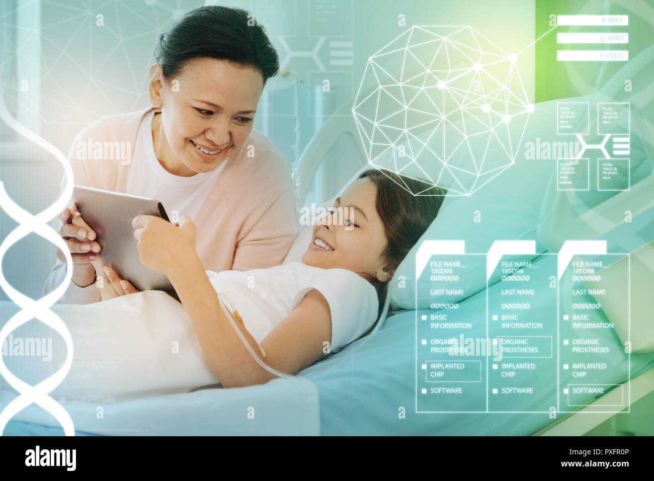 Ill child holding a tablet while a mother smiling to her Stock Photo