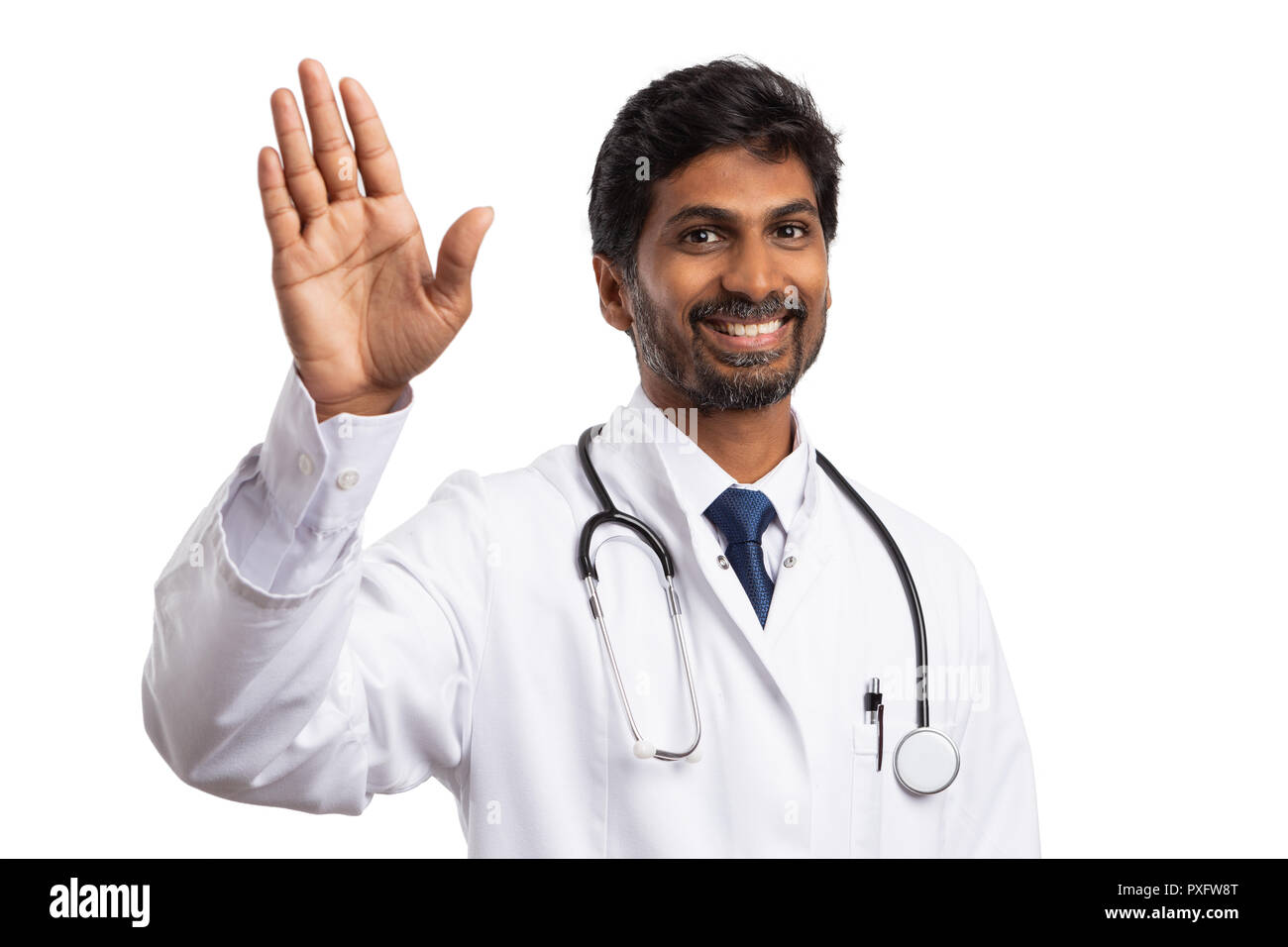 Friendly indian medic waving hand  smiling with cheerful expression isolated on white studio background Stock Photo