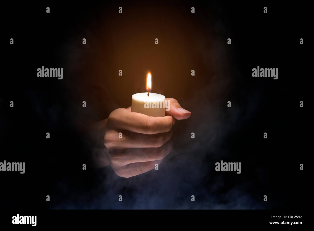 Hands holding candle over dark background. Christian Pray Stock Photo Alamy
