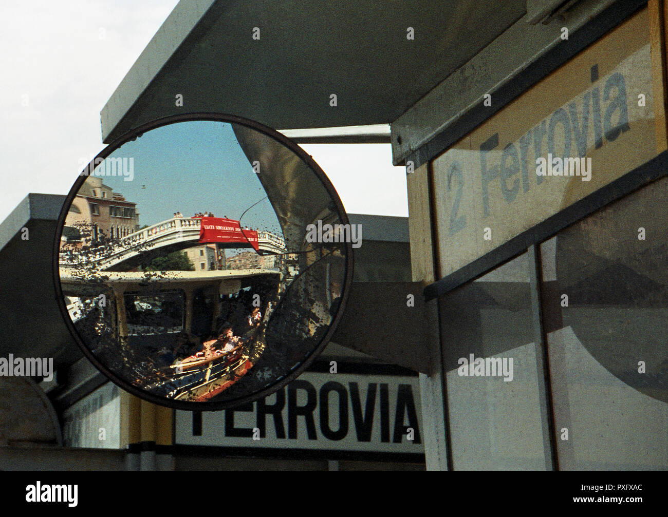 Venetian Pont Scalzi bridge reflected in a mirror at Ferrovia waterbus stop, by the train statin in Venice, italy Stock Photo