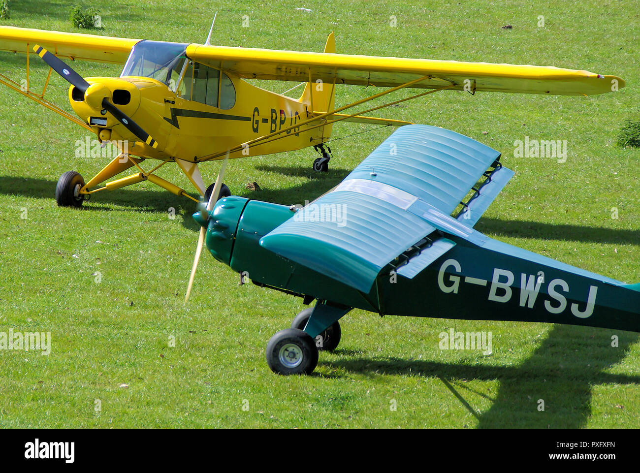 Denney Kitfox Mk3 plane and Piper PA18 Super Cub planes on the grass at Henham Park Suffolk countryside grass airstrip. Light aviation Stock Photo