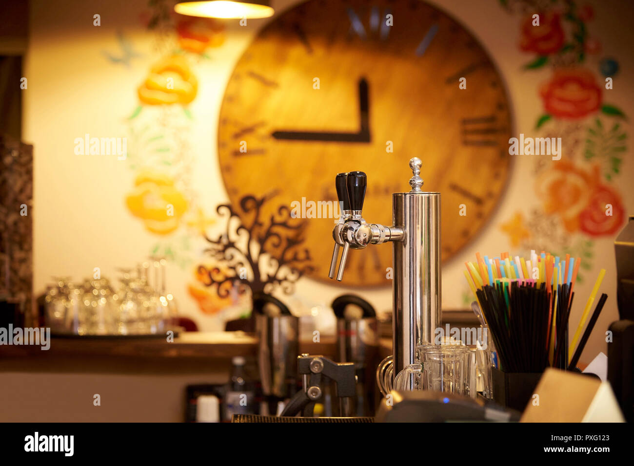 Beer tap on a blurred background of the clock in the restaurant Stock ...
