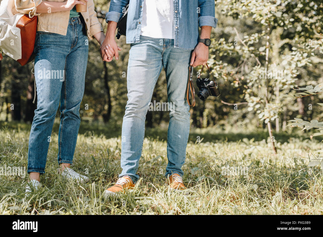 cropped shot of couple holding hands in park Stock Photo - Alamy