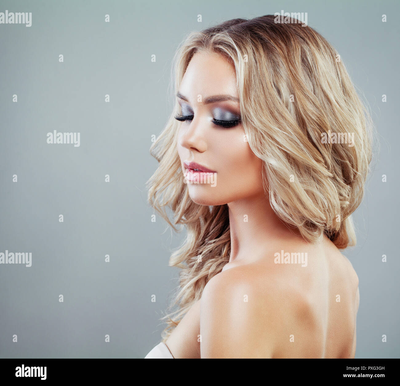 Perfect young woman with wavy blonde hair and makeup on banner ...