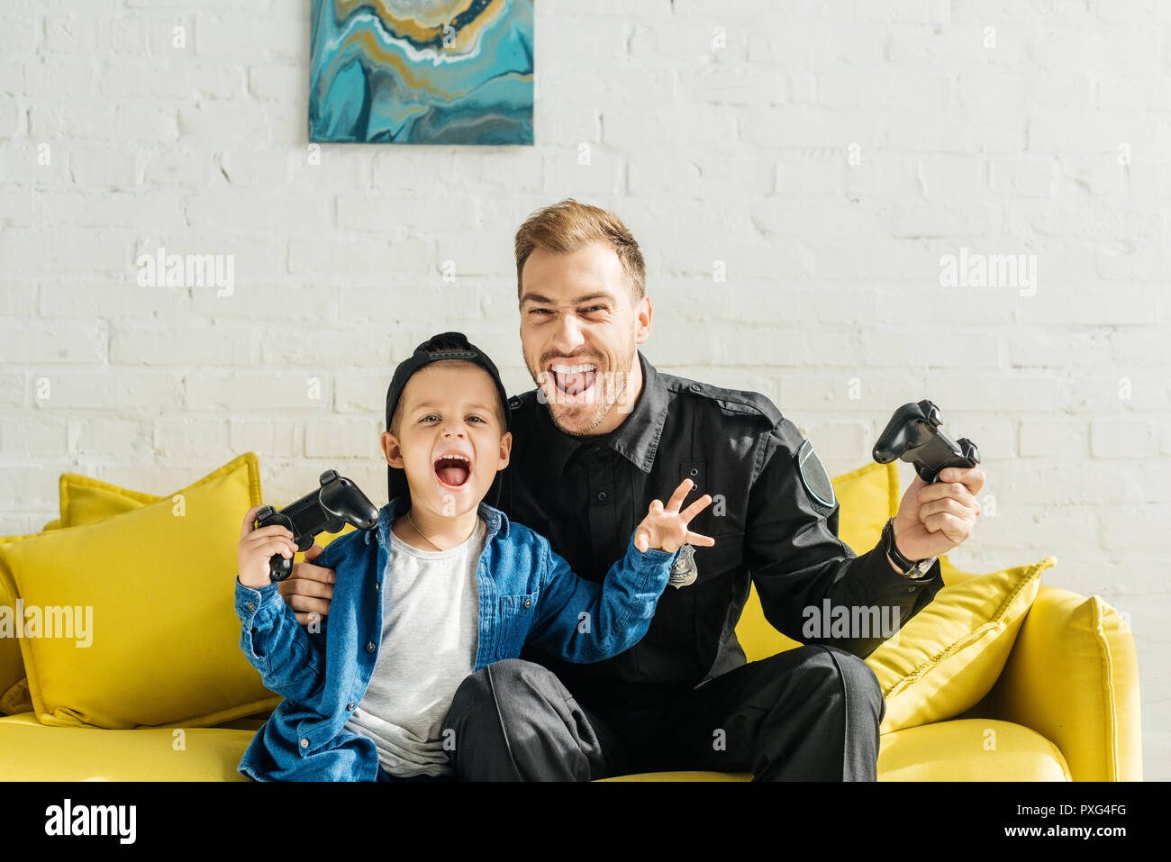 Emotional Young Father In Police Uniform And Son Playing Video