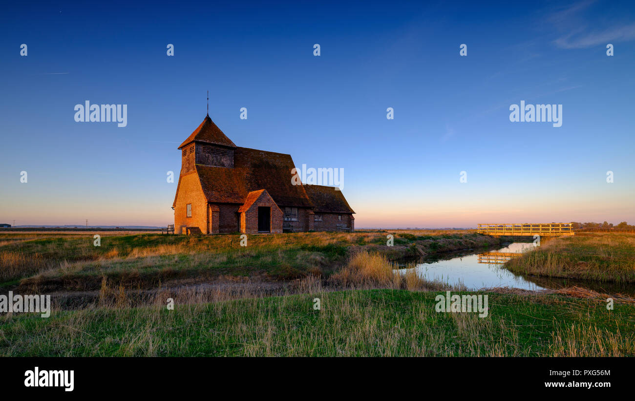 Autumnal clearing evening sunset over St Thomas a Becket Church, Fairfield, i the Romney Marsh, Kent, UK Stock Photo