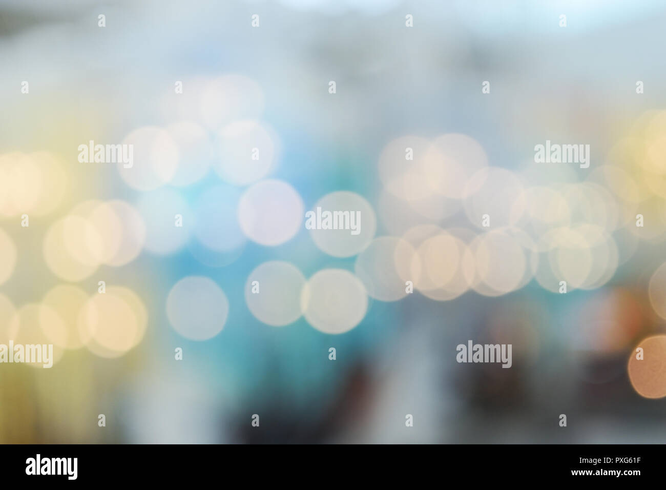 Bokeh from indoor lighting, Colorful light circles spread on blue with yellow and green background for the celebration of the holiday season Stock Photo