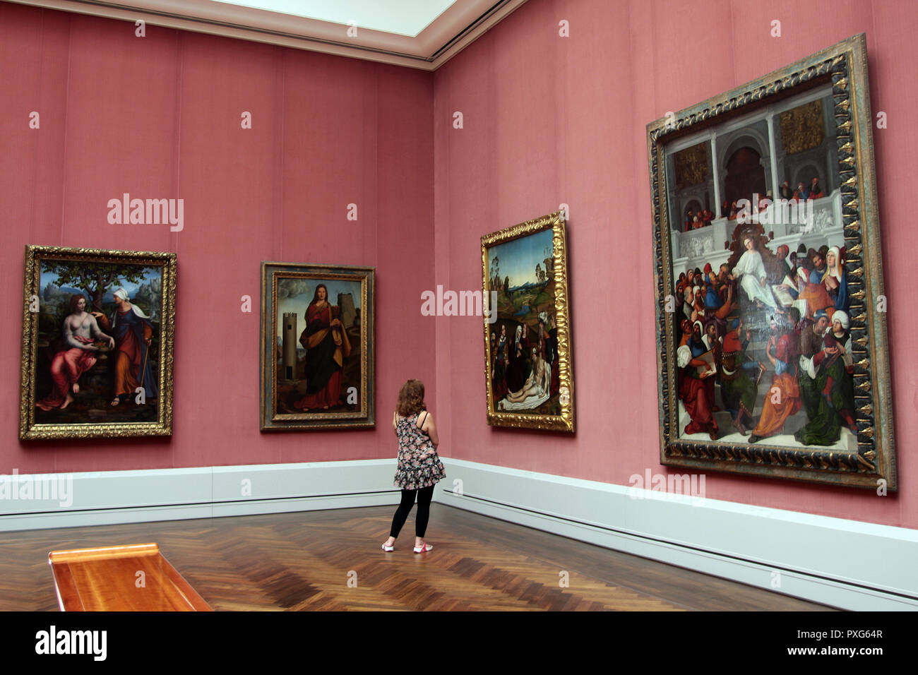 A lone art lover admiring the paintings in this art gallery in the German city of Berlin. Stock Photo