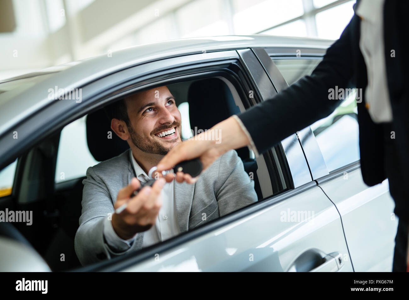 Professional salesperson during work with customer at car dealership Stock Photo Alamy