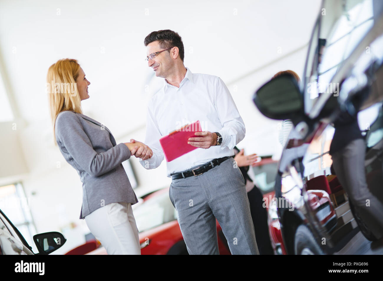 Successful businessman in a car dealership sale of vehicles to customers Stock Photo Alamy