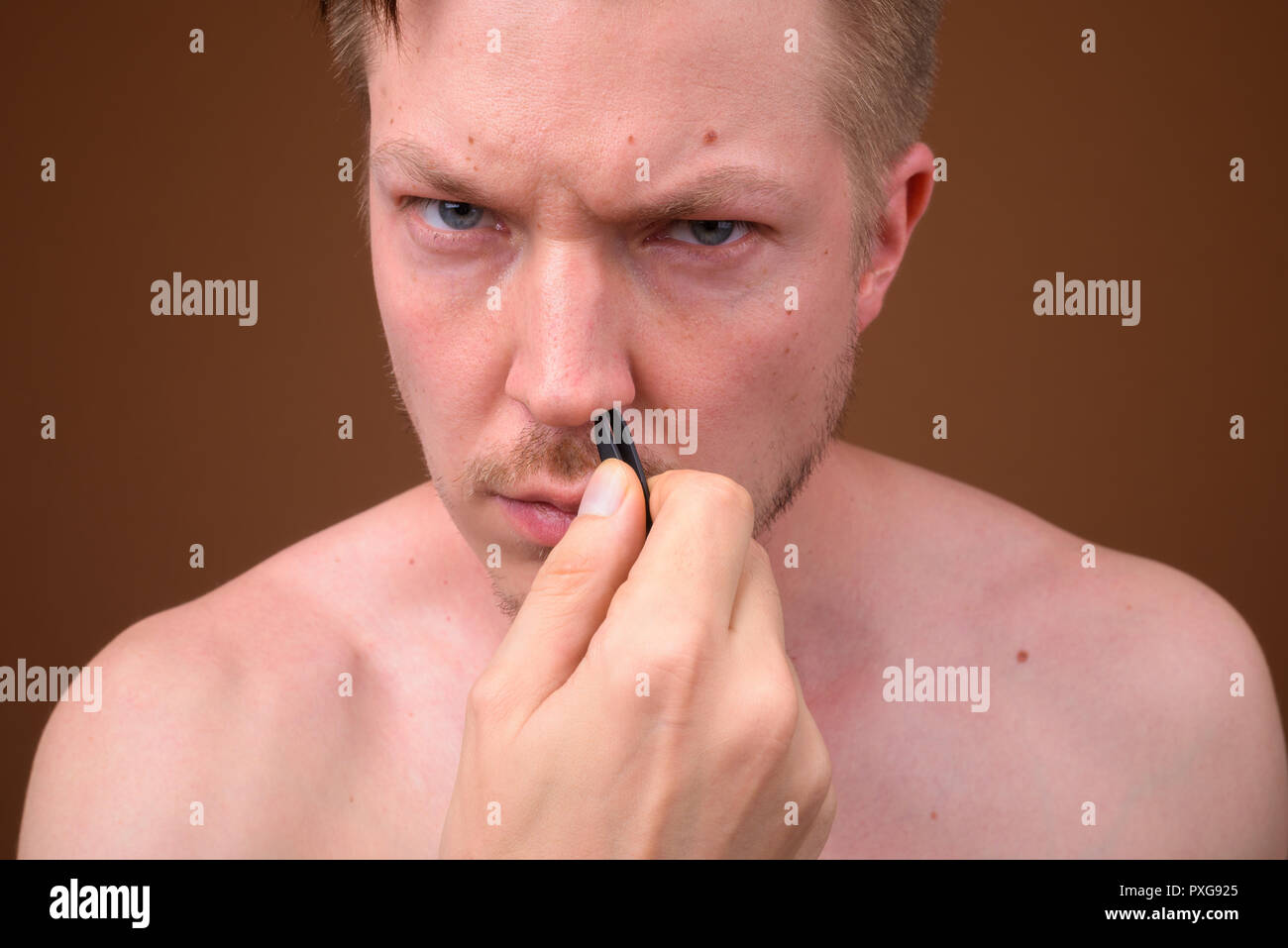 Man Picking Up And Removing His Nose Hair Stock Photo 222863821