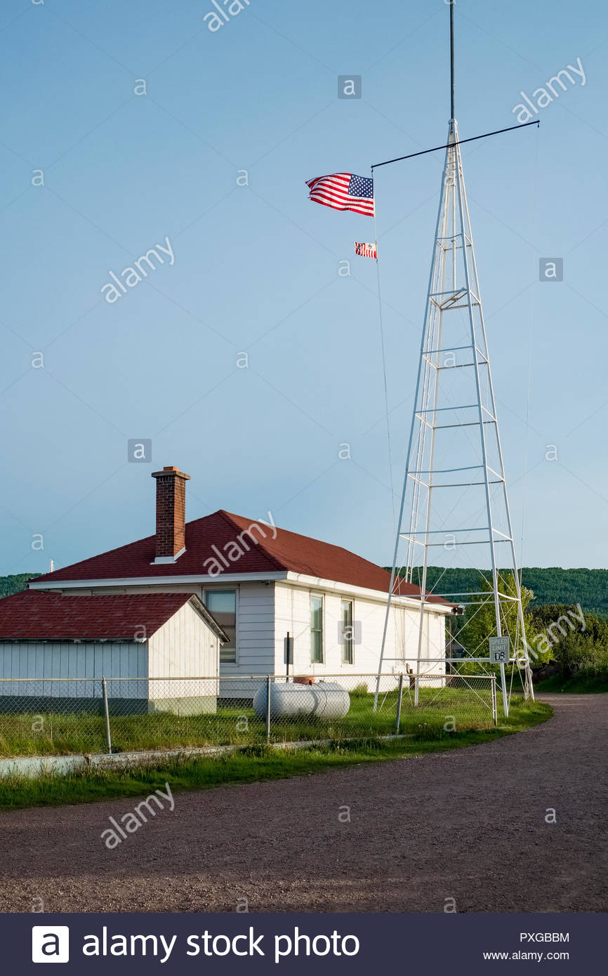 American And U S Coast Guard Flags Fly On Radio Tower Of Coast