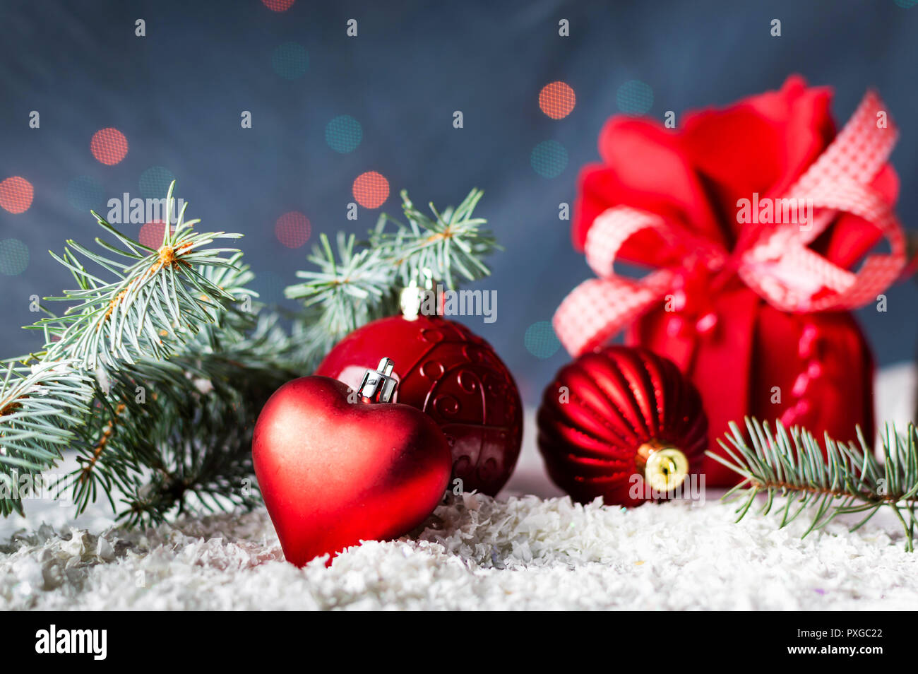 Red Christmas ornaments and fir branch with festive background Stock Photo