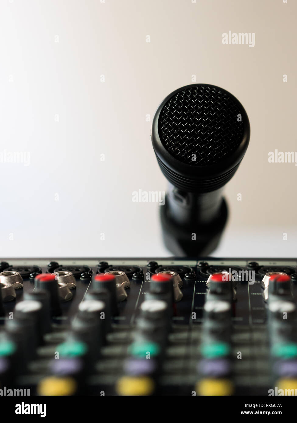 Black wireless microphone and audio mixer in studio indoors Stock Photo
