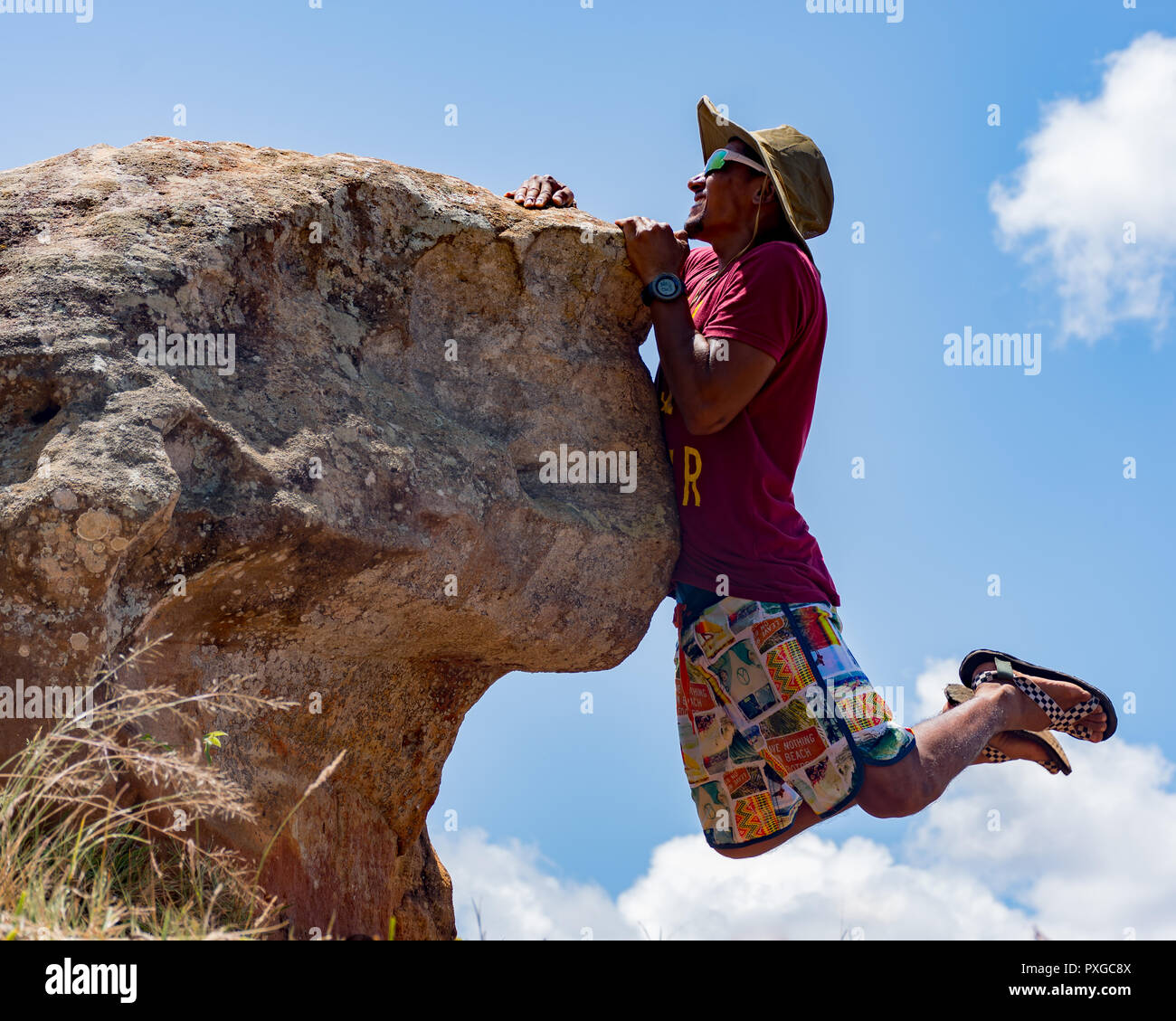 Man hanging on cliff hi-res stock photography and images - Alamy