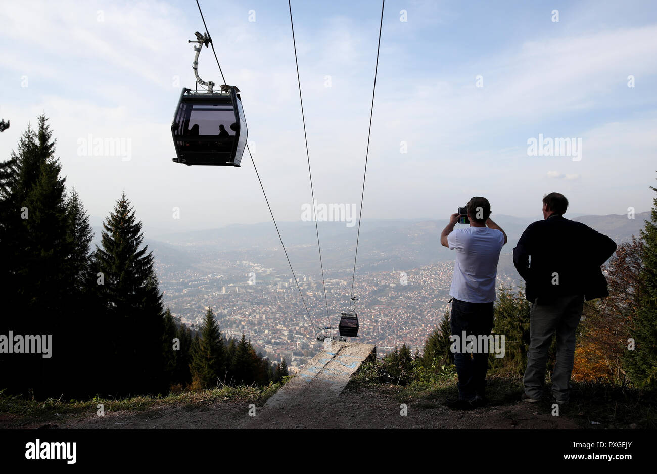 Tourists Look At A View Of Sarajevo Next To The Mount Trebevic Cable 