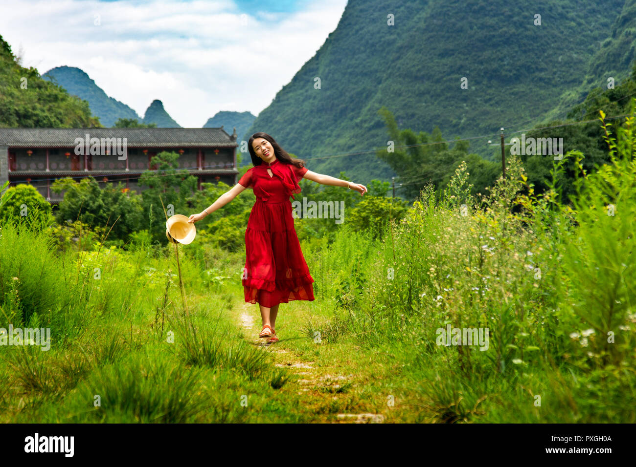 Happy Asian girl exploring nature of Yangshuo in China Stock Photo