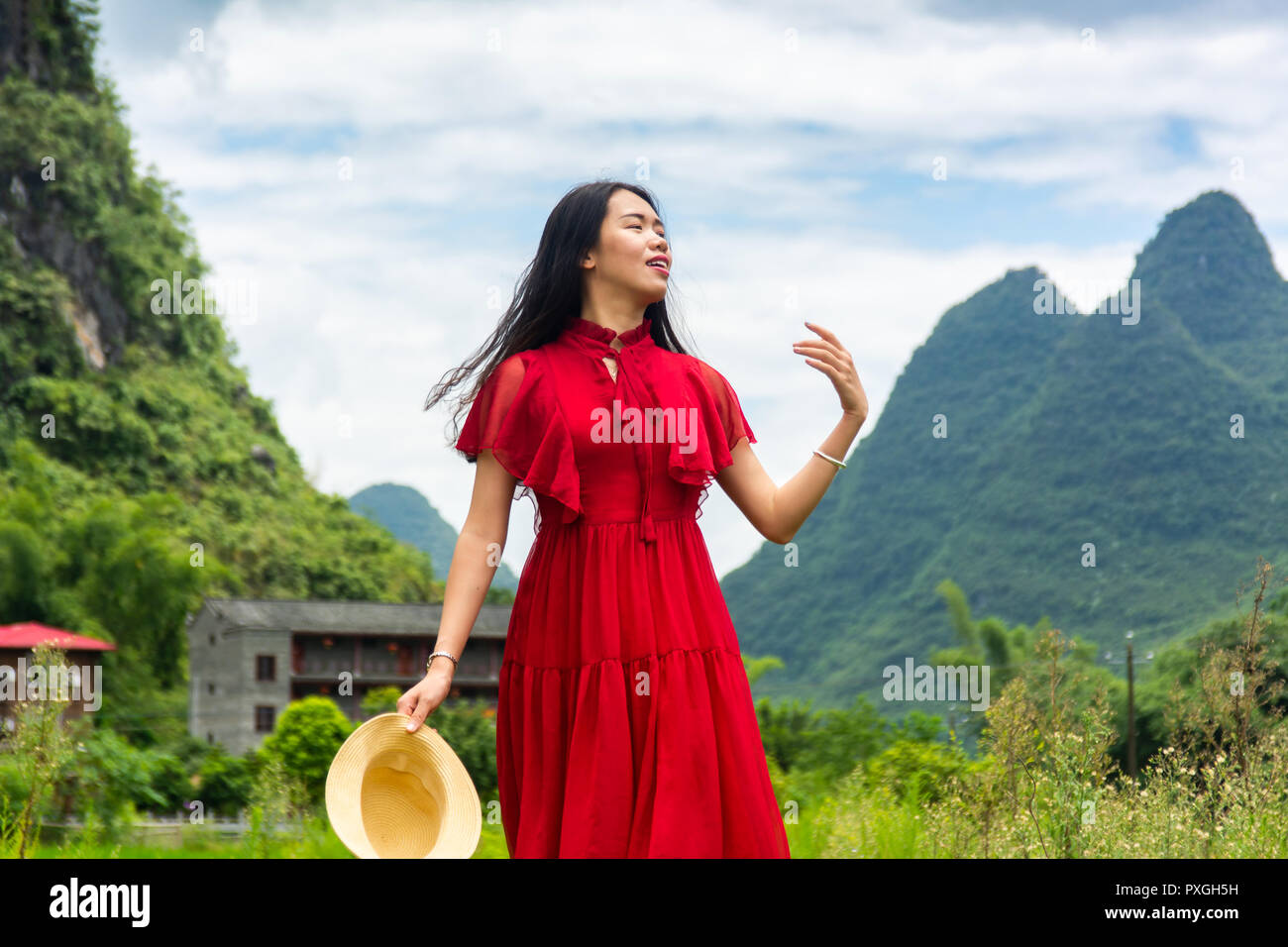 Happy Asian girl exploring nature of Yangshuo in China Stock Photo