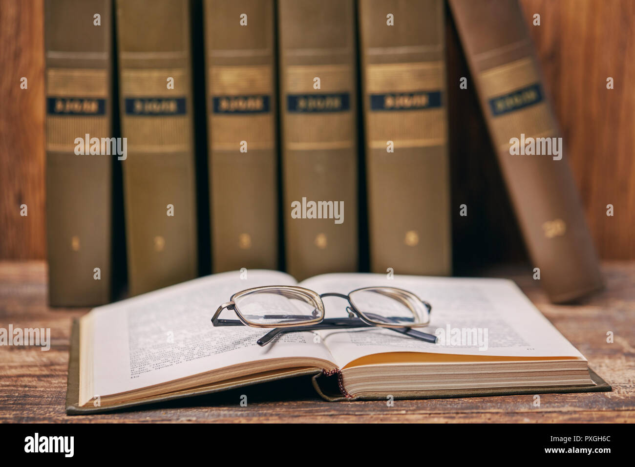 Open book with glasses on the table Stock Photo