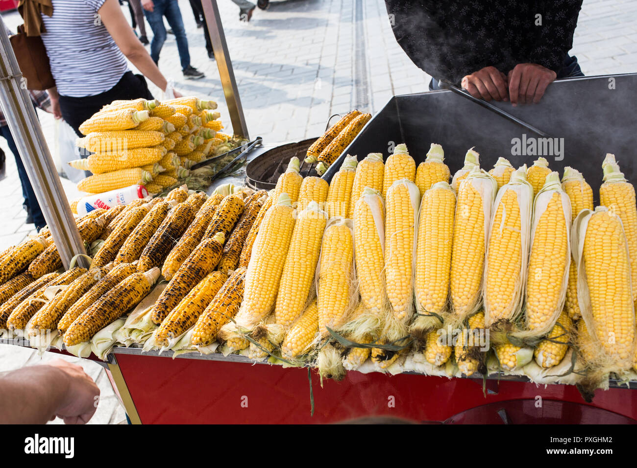 Fresh boiled and roasted corn is famous street food of Istanbul, Turkey. Grilled corn on the hot stove Stock Photo