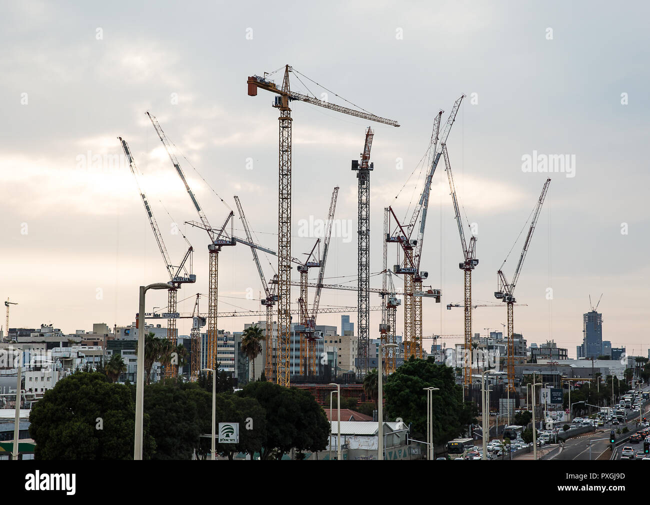 Petah Tikva , Israel - October 15 . 2018 : Construction site of high rise building in Petah Tikva, on October 15, 2018. Vew Lifting cranes at sunset . Stock Photo