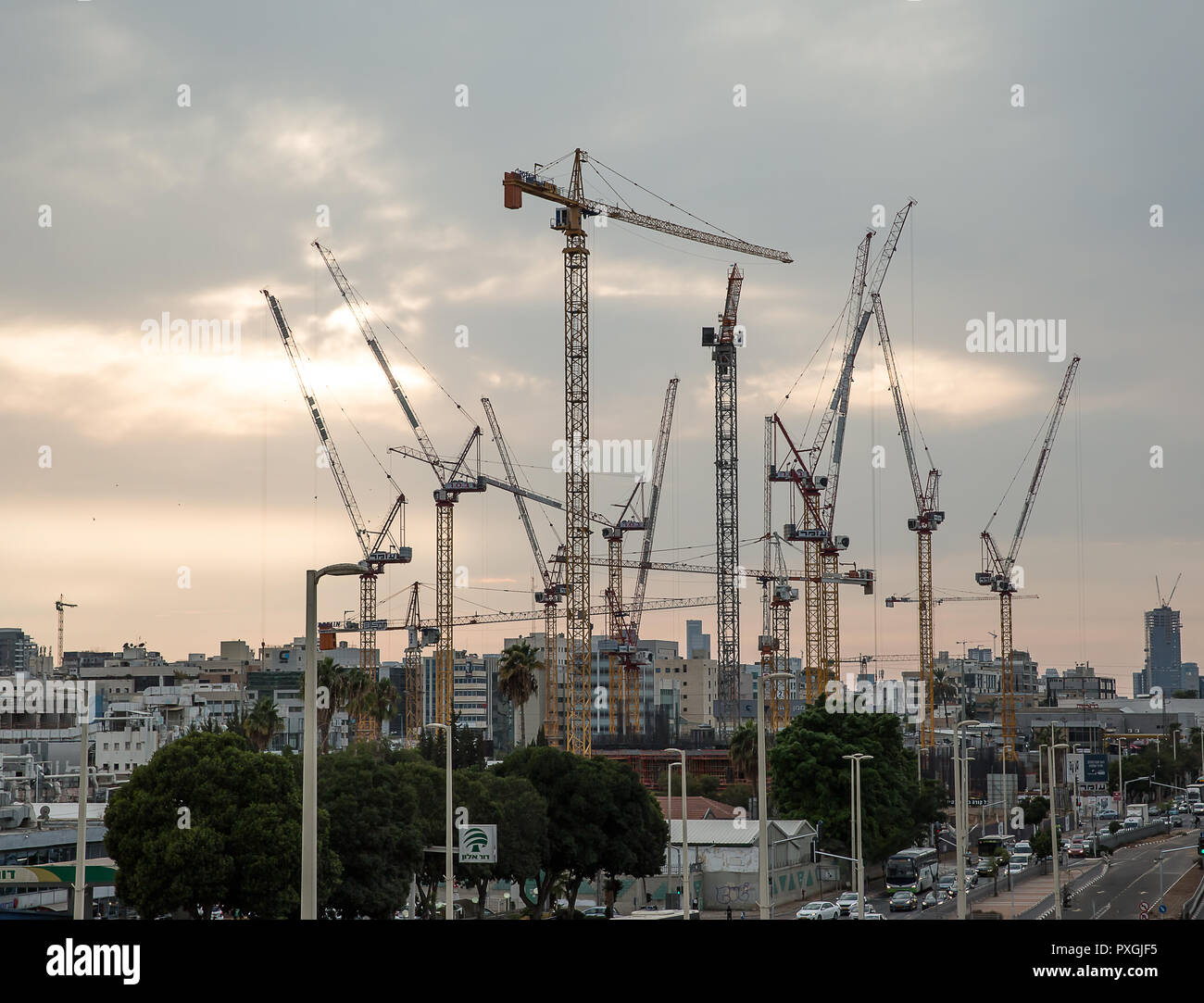 Petah Tikva , Israel - October 15 . 2018 : Construction site of high rise building in Petah Tikva, on October 15, 2018. Vew Lifting cranes at sunset . Stock Photo
