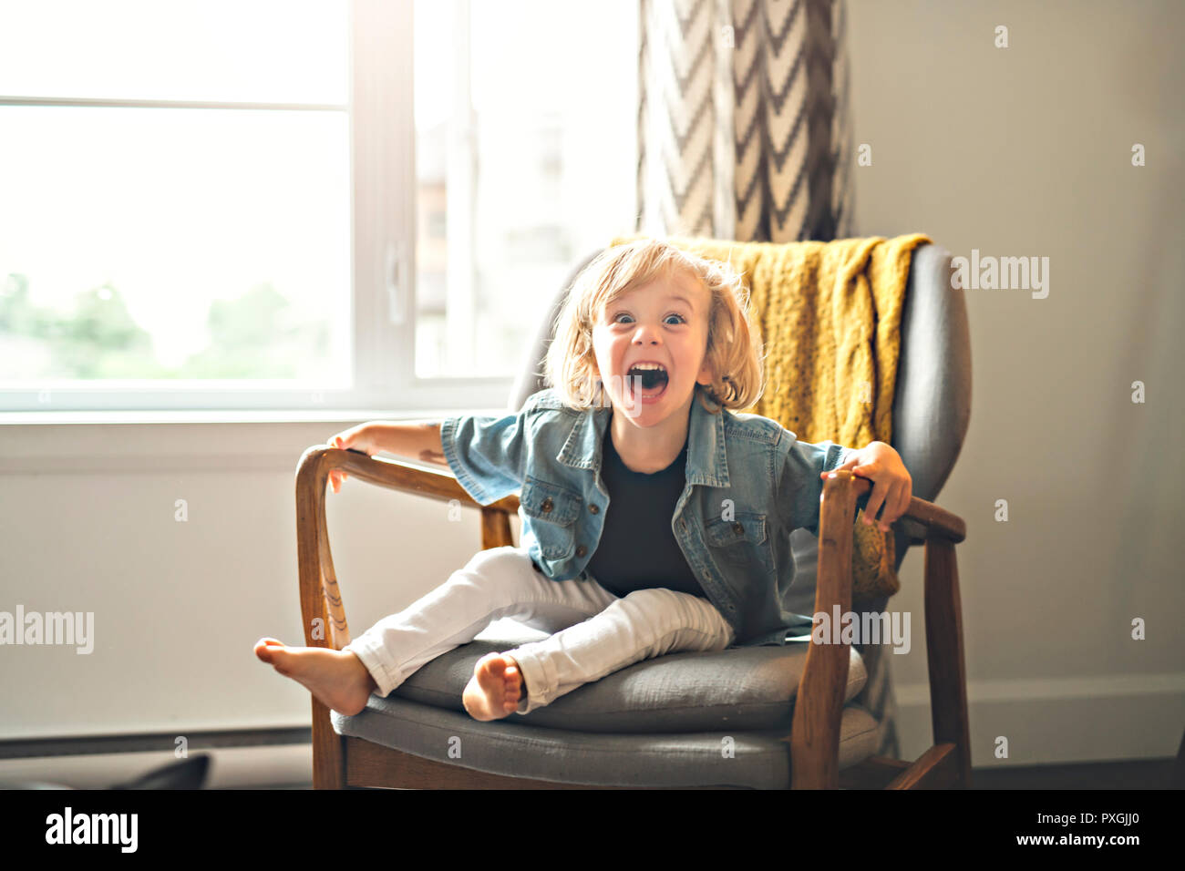 A Cute two years old child sit on chair Stock Photo