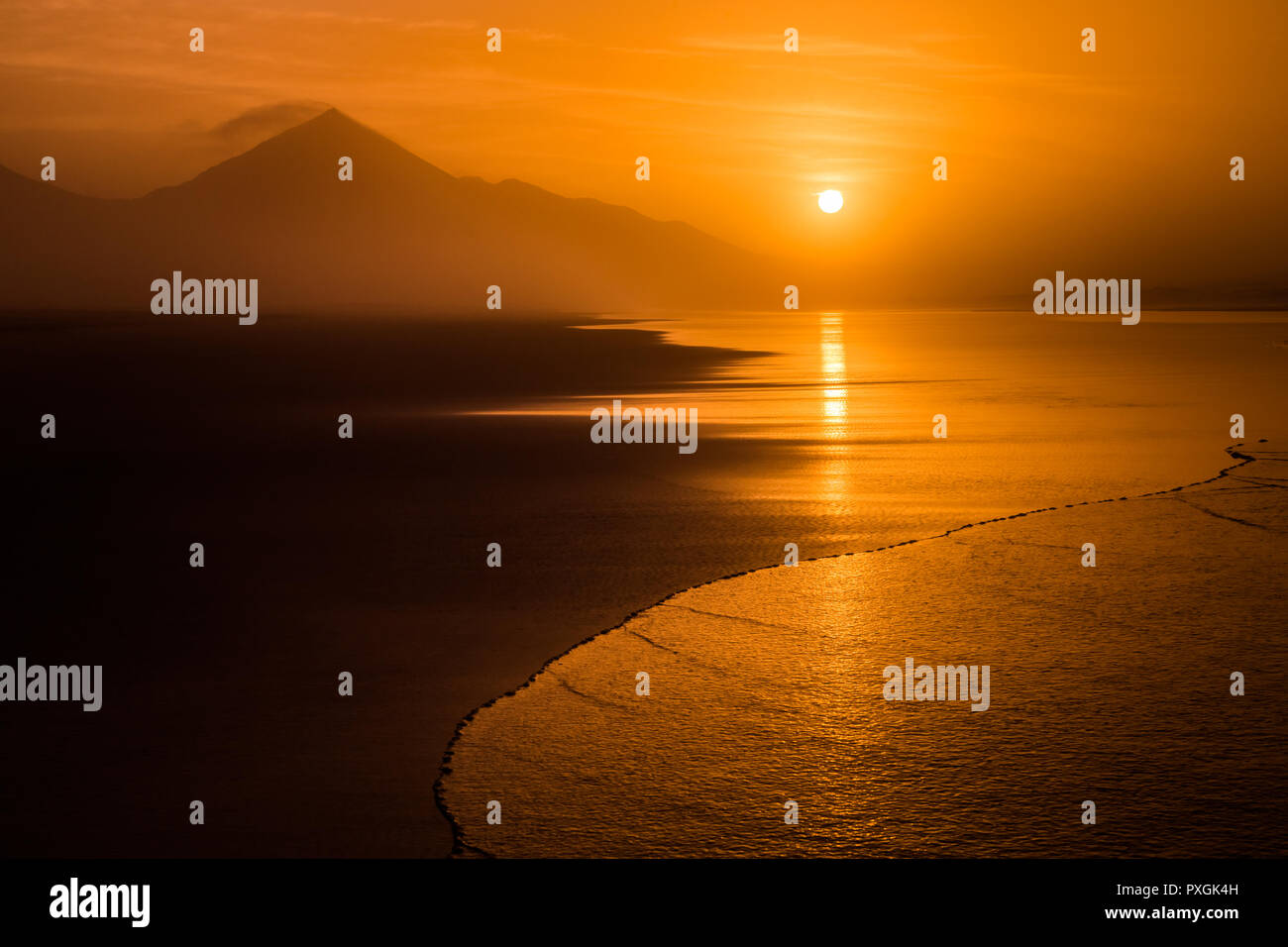 Sunset tropical Cofete beach landscape with silhouette of hills in Fuerteventura, Canary Islands, Spain. Stock Photo