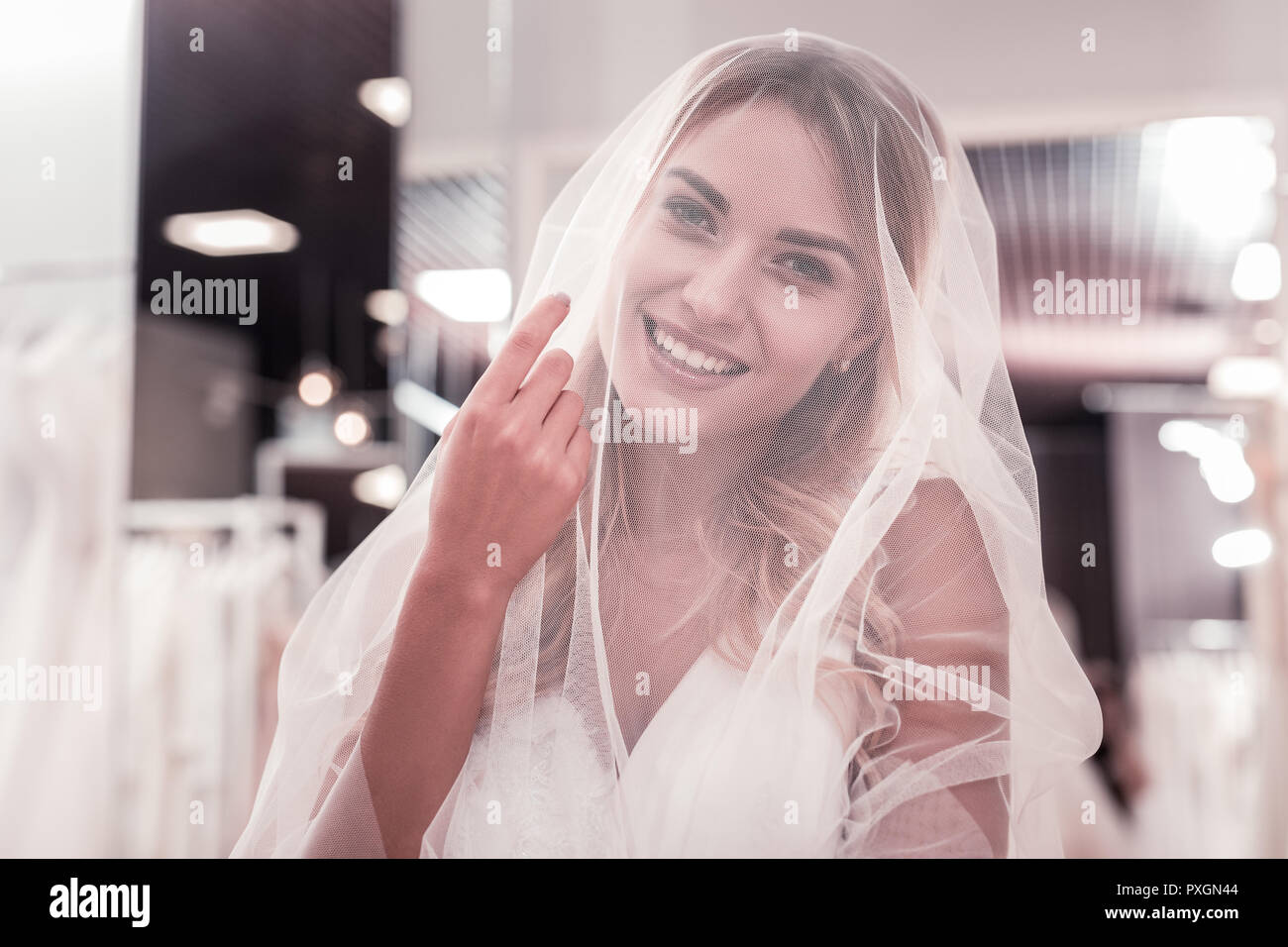 Nice positive woman looking at you through the veil Stock Photo