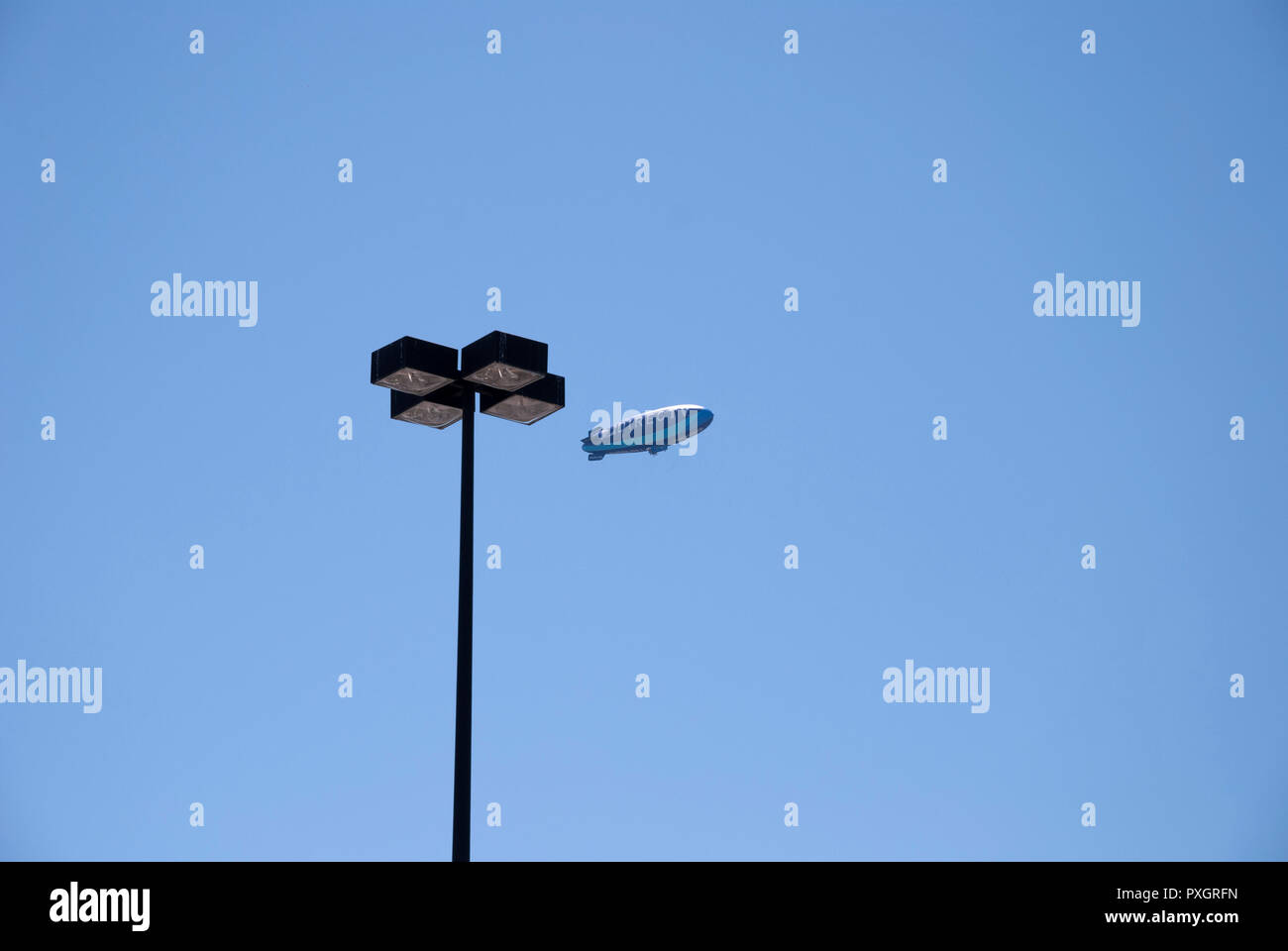 Advertising blimp for Direct TV circles overhead of a city in North Florida. Stock Photo