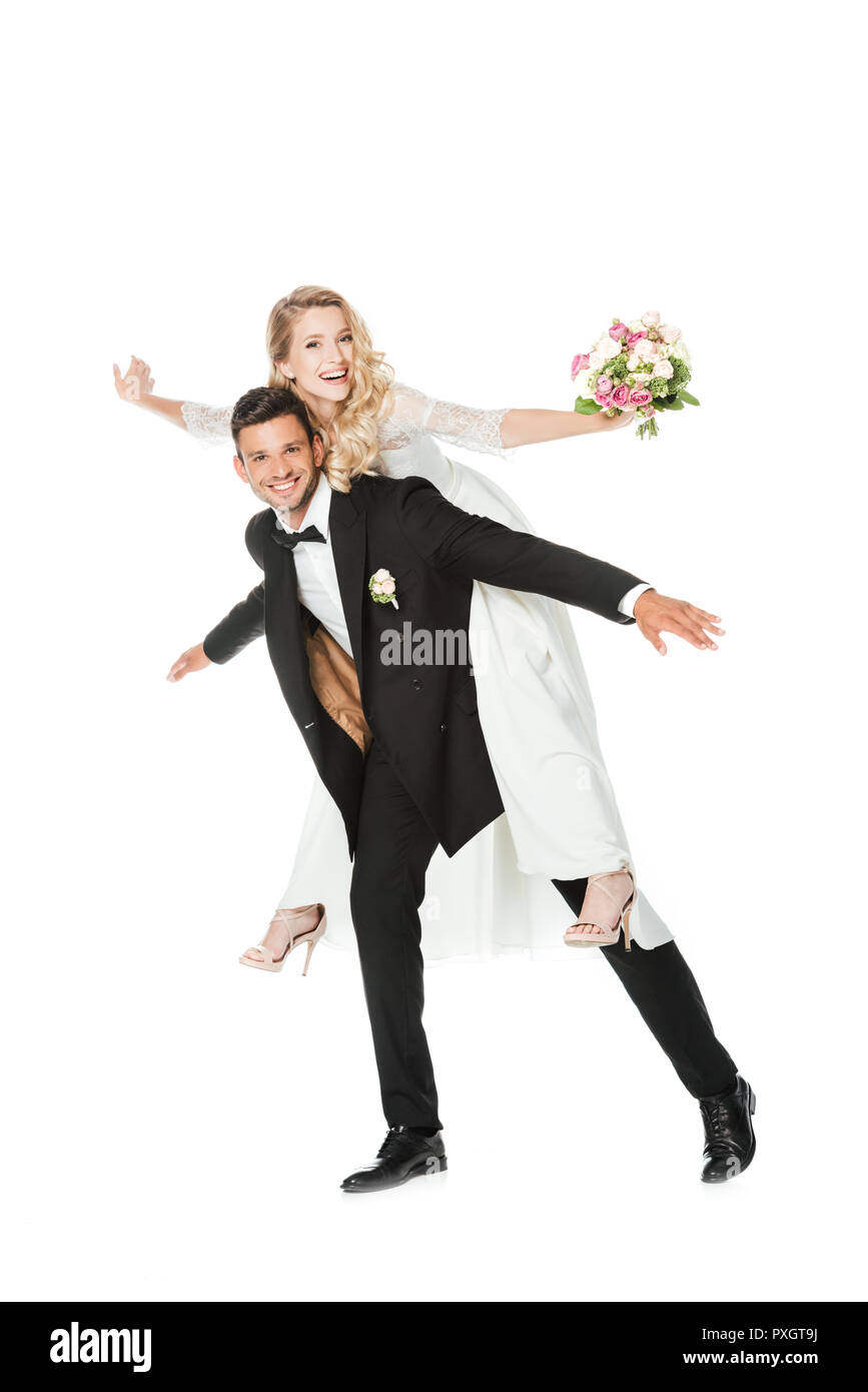happy young bride piggybacking on groom isolated on white Stock Photo