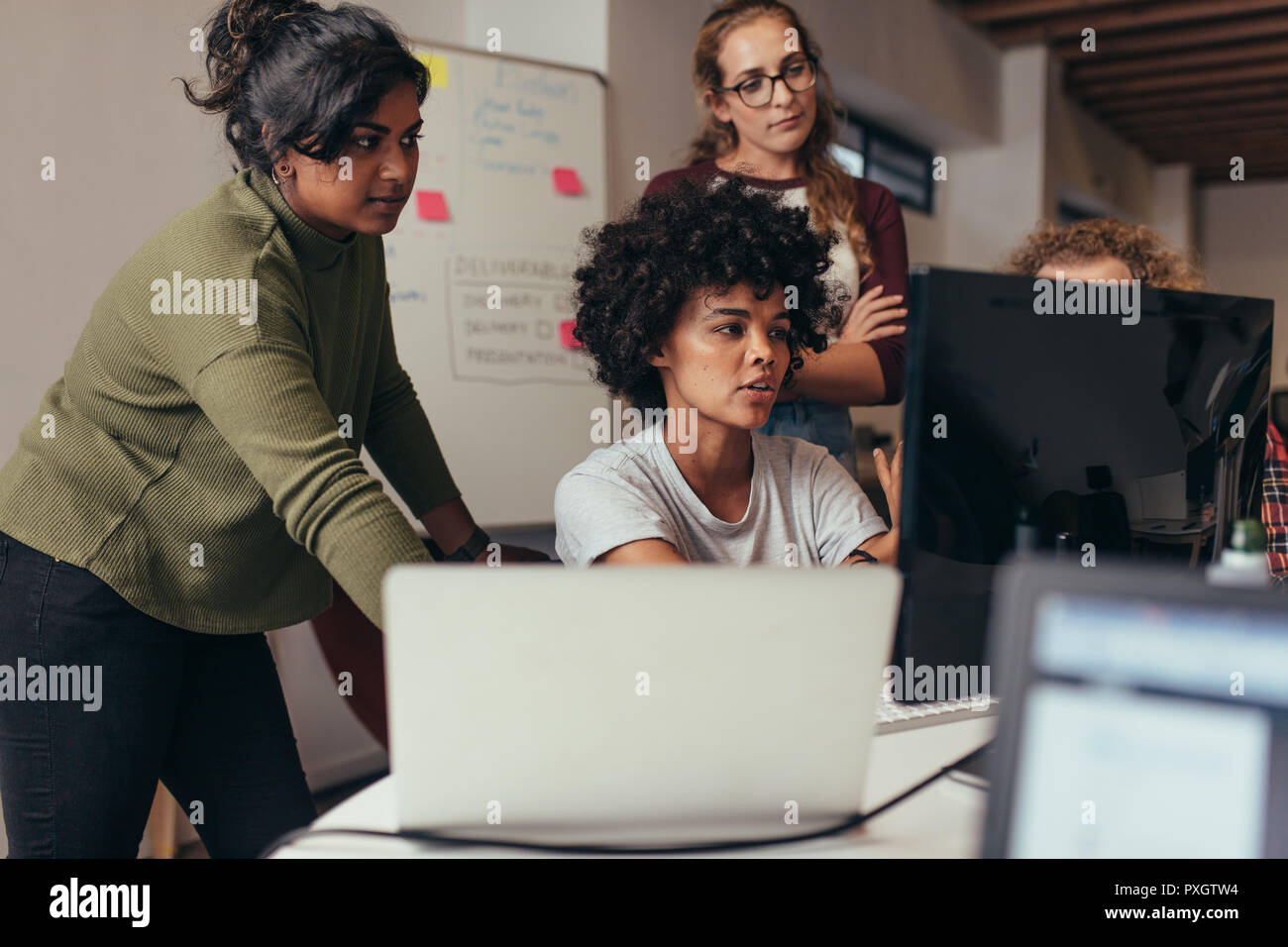 Software engineers working on project and programming in company. Startup business group working as team to find solution to problem. Woman programmer Stock Photo