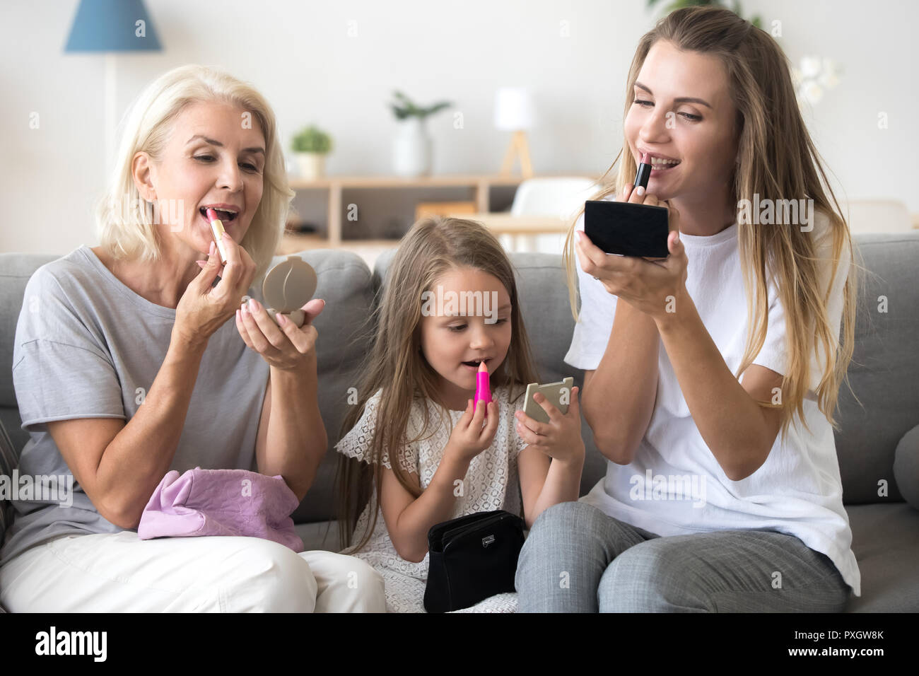 Mother, daughter and granny put make up spending time together Stock Photo