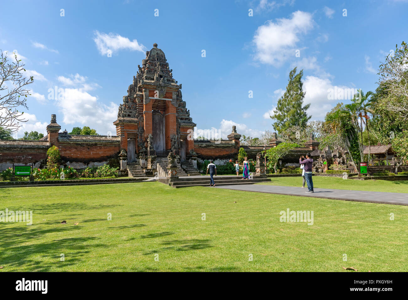 Badung, Indonesia - September 12, 2018: Tourist taking photo at the entrance of Taman Ayun temple, an ancient royal temple of Mengwi Empire. Stock Photo