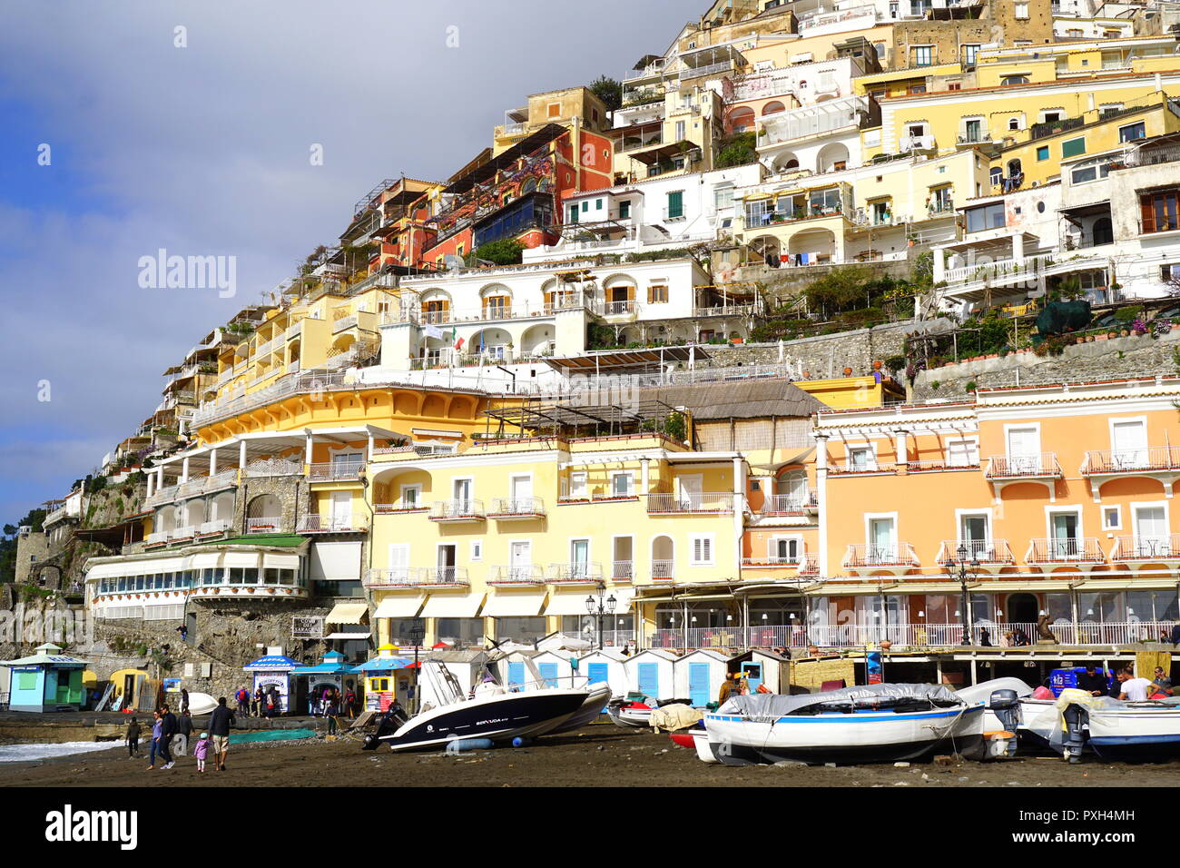 Beach with the backdrop of colorful homes on a steep mountain in Positano, a cliffside village on southern Italy's Amalfi Coast Stock Photo