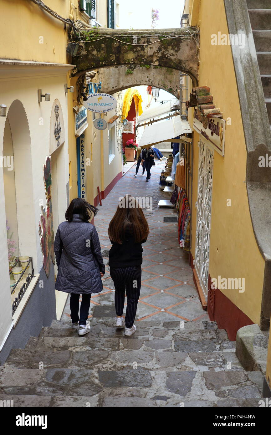 Travelers walking on the steep narrow street in Positano, a cliffside village on southern Italys Amalfi Coast Stock Photo