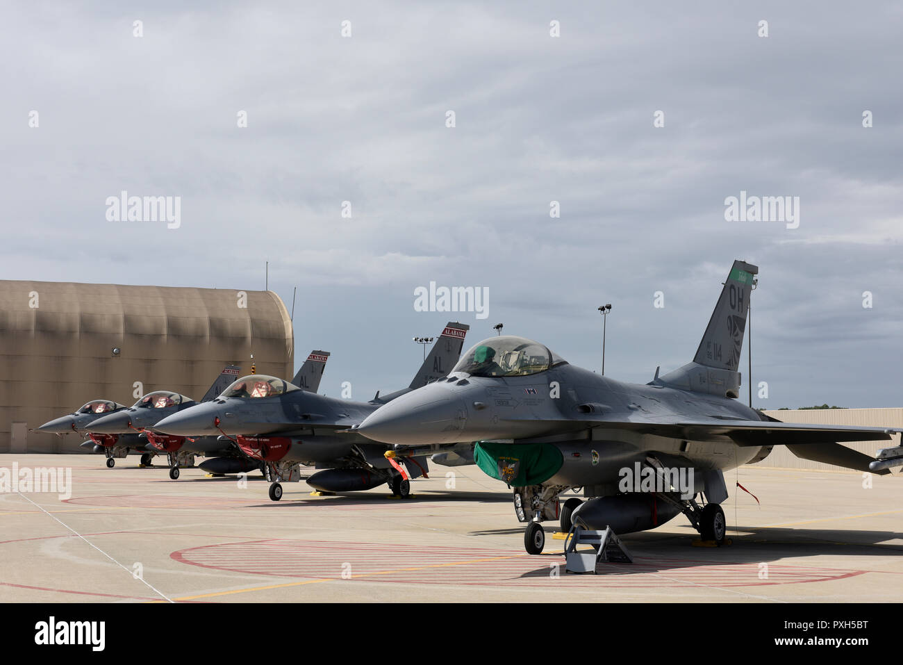 U.S. Air Force F-16 Fighting Falcons from the 187th Fighter Wing, Alabama Air National Guard sit alongside F-16s from the 180th Fighter Wing, Ohio Air National Guard in Swanton, Ohio after evacuating Hurricane Michael on Oct. 9, 2018. Many different units around the nation temporarily hosted aircraft from the gulf region to safeguard military assets, highlighting the teamwork and integration of the U.S. Air National Guard. (U.S. Air National Guard photo by Staff Sgt. Shane Hughes) Stock Photo