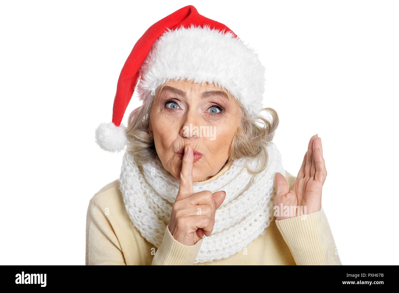 Portrait of senior woman in Santa hat gesturing silence Stock Photo - Alamy
