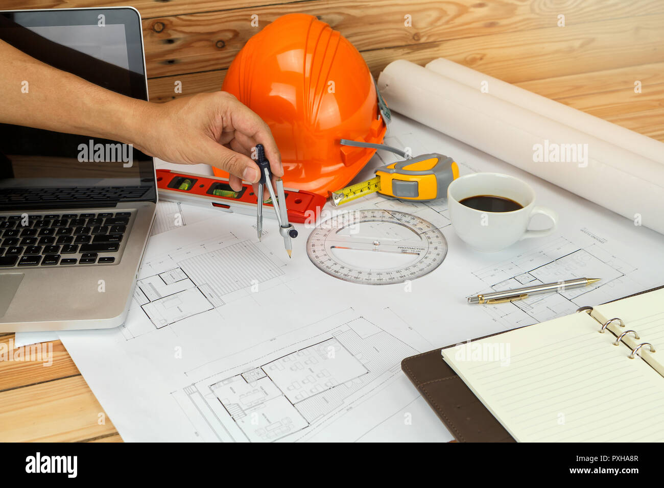 An architect or engineer working on blueprint, An architect or engineer uses a divider gauge on the blueprint., architectural concept Stock Photo
