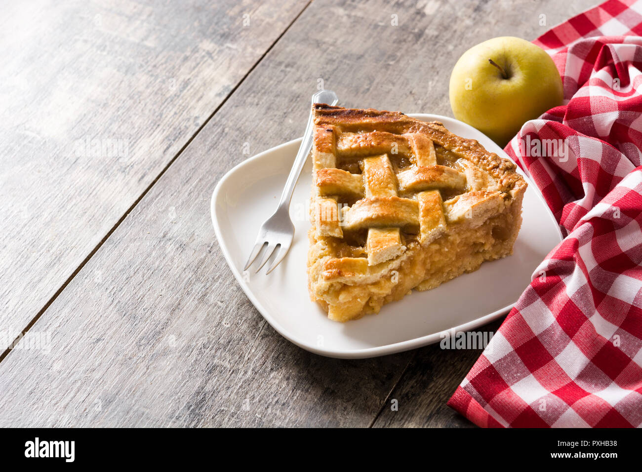 Homemade apple pie slice on wooden table. Copyspace Stock Photo