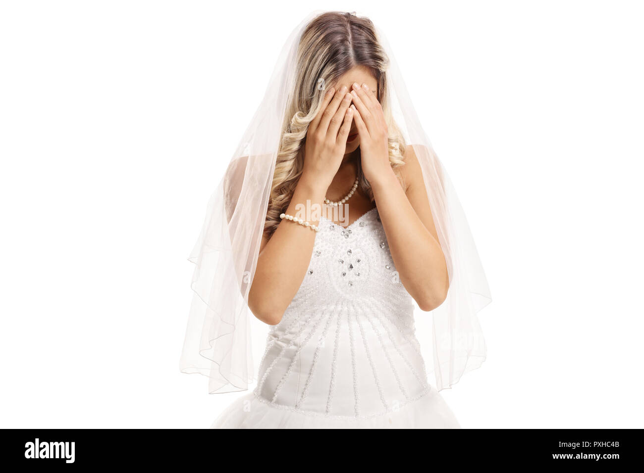 Sad bride covering her face with hands isolated on white background Stock Photo