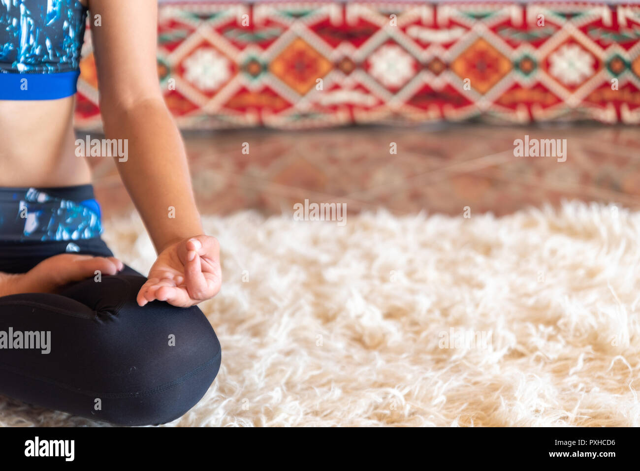 Young woman sitting in lotus position, yoga concept Stock Photo - Alamy