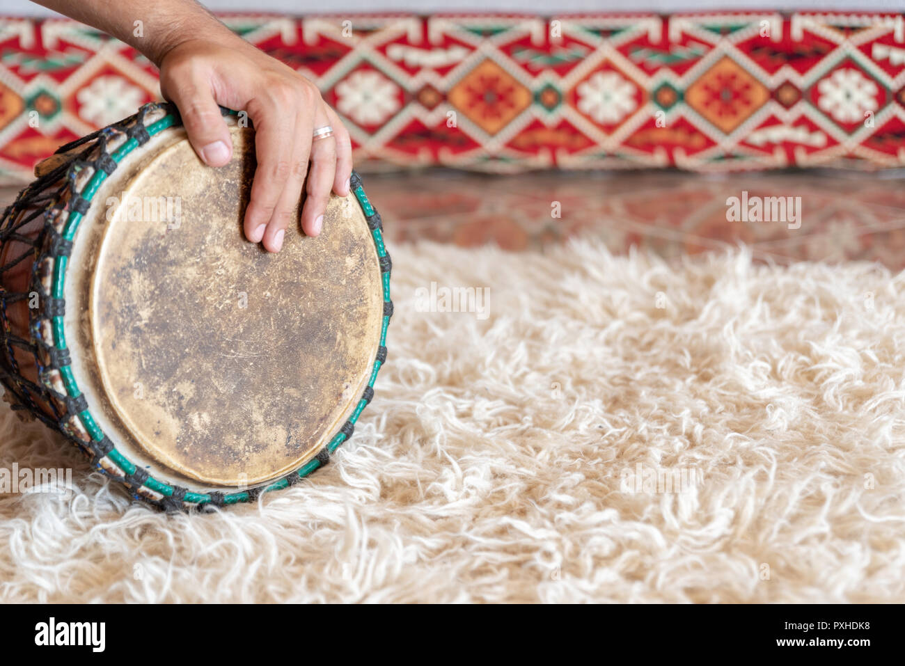 Traditional drum on white carpet Stock Photo