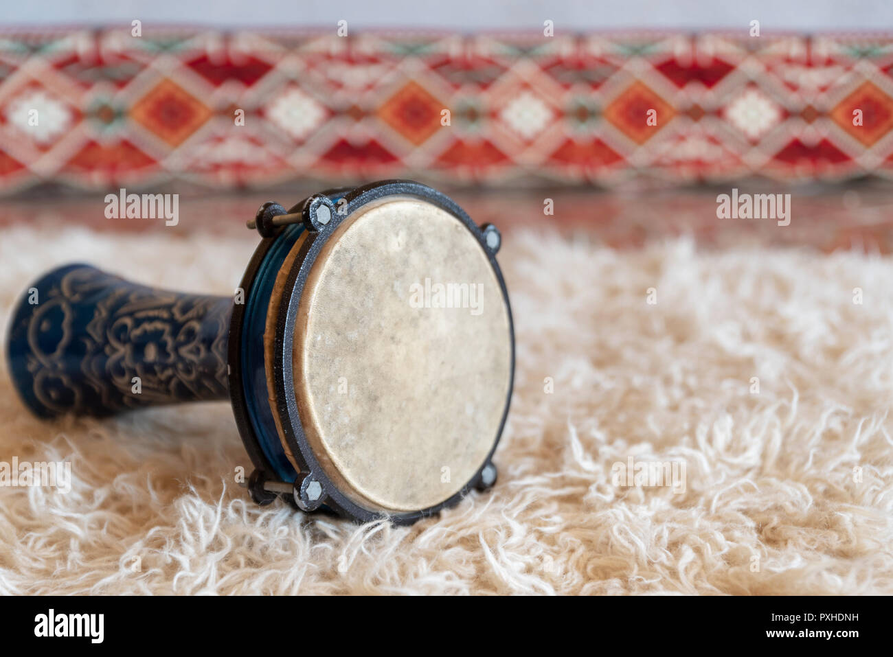 Traditional drum on white carpet Stock Photo