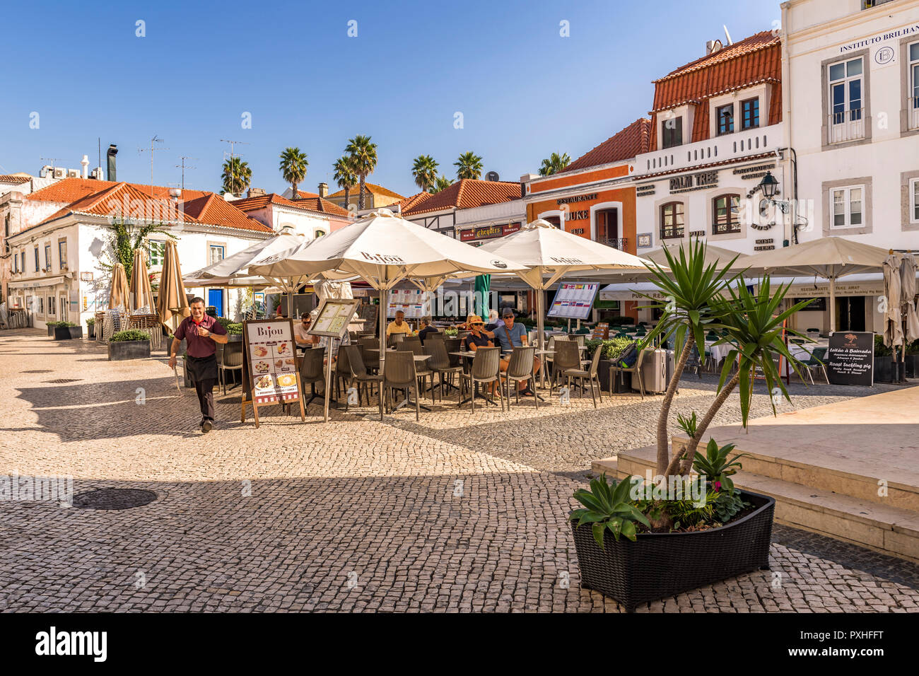 Open air restaurant on a traditional cobbled street Cascais Portugal Stock Photo