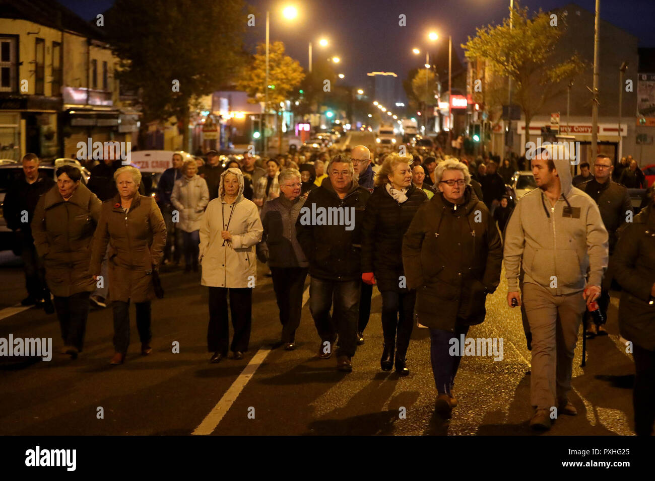 Members of the public take part in a memorial march in Belfast, to mark the 25th anniversary of the Shankill Road bombing in which nine innocent people were killed by an IRA bomb. Stock Photo