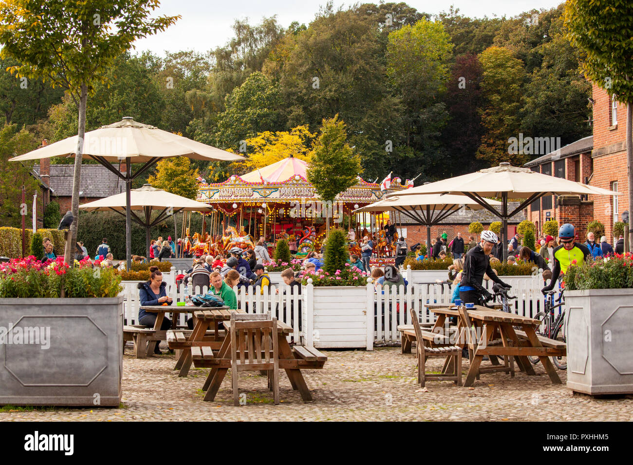 People Enjoying Autumn Sunshine Outside The Cafe Beside The Carousal Roundabout At The National Trust Property Of Tatton Park At Knutsford Cheshire Uk Stock Photo Alamy