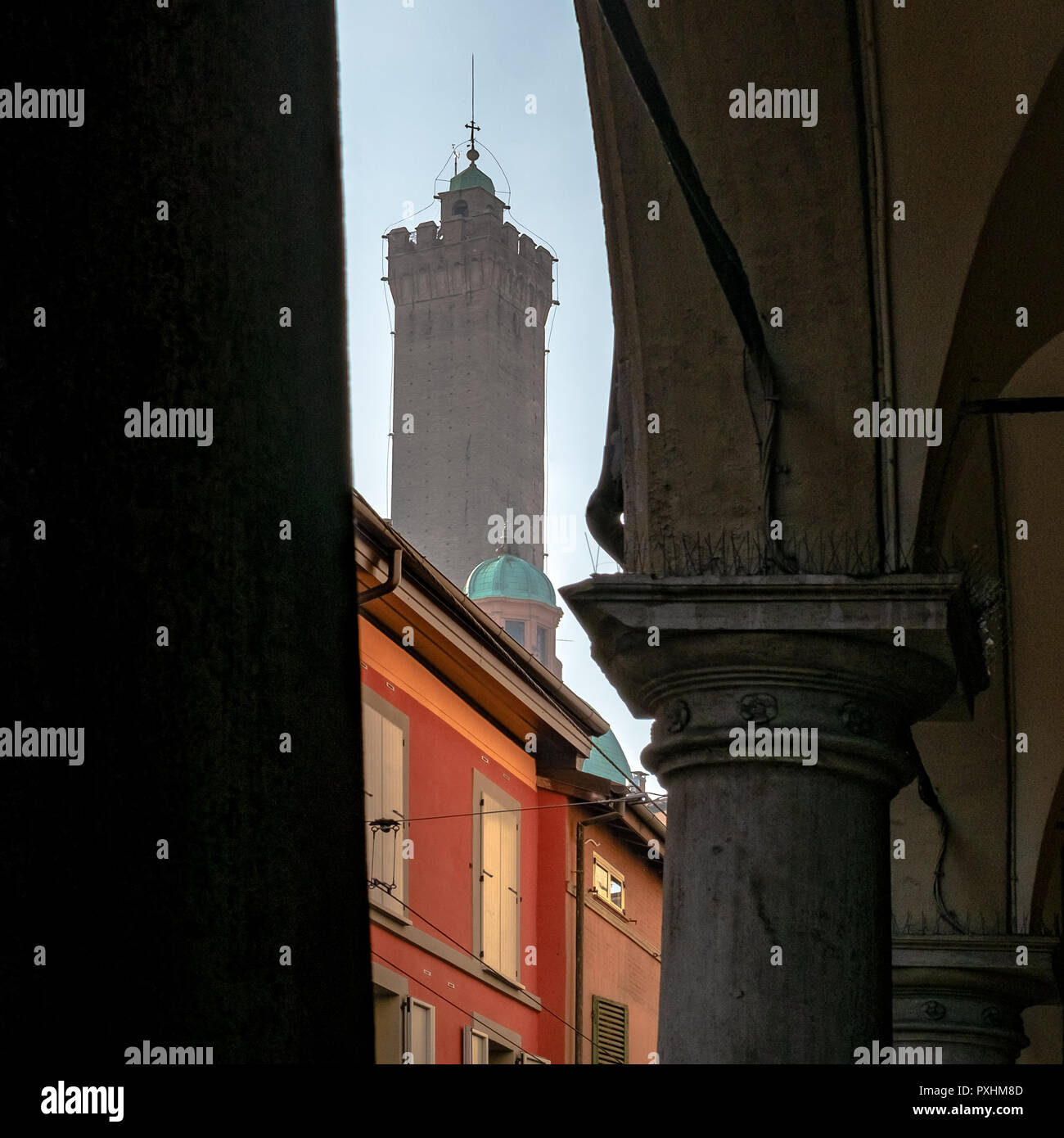 Glimpse of the famous Asinelli tower. Taken from under a porch. Bologna, Emilia Romagna, Italy. Stock Photo
