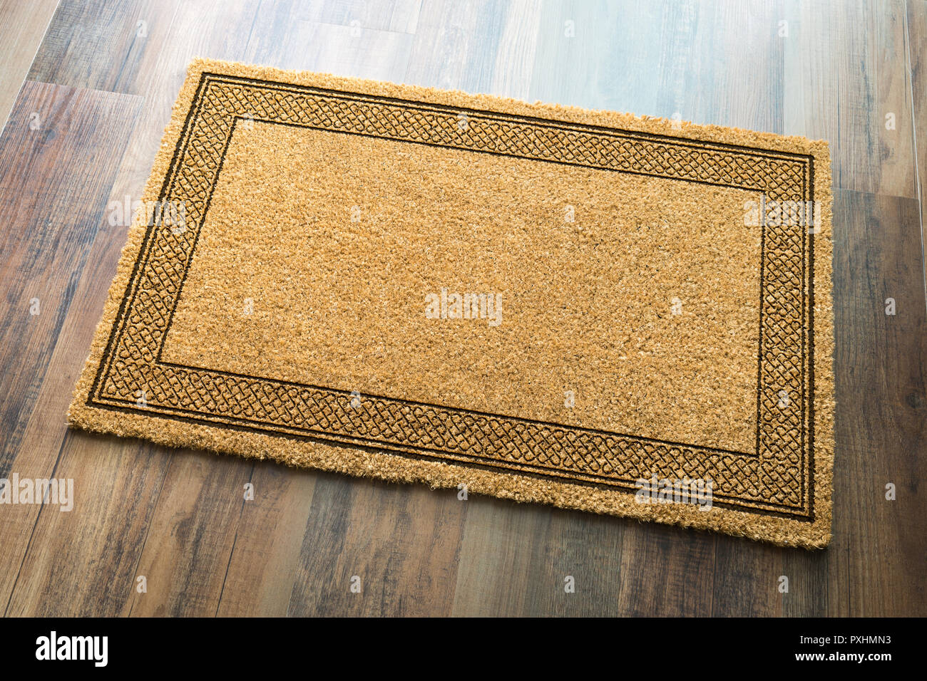 Blank Welcome Mat On Wood Floor Background Ready For Your Own Text. Stock Photo