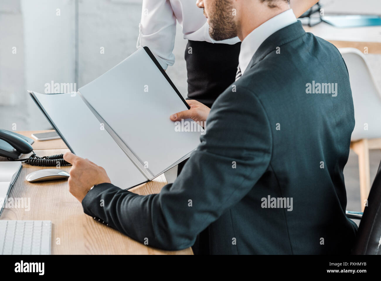 cropped image of businessman reading documents in office Stock Photo